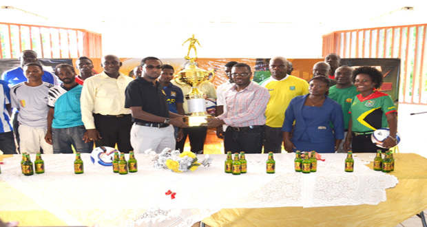 GT Beer Brand Manager Jeff Clement makes a presentation to UDFA President Sharma Solomon to mark the official launching of the UDFA GT Beer Football Tournament.