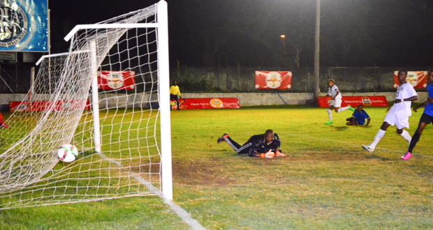 Black Pearl goalkeeper dives in vain as a Dwayne McLennon (far left) strike creeps into his goal. (Samuel Maughn photo)