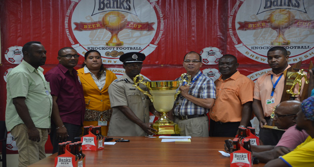 GFA president Clifton Hicken collects the winner trophy from Banks Beer Brand manager Brian Choo-hen in the presence of other GFA Executives. (Delano Williams Photo)