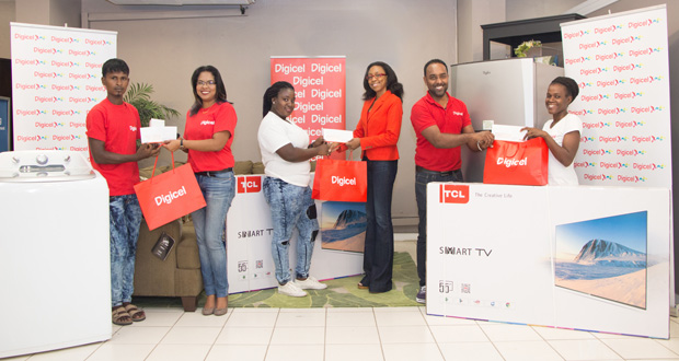Digicel’s Head of Marketing, Ms. Jacqueline James, Advertising Manager Ramesh Rupchand and Communications Manager Vidya Sanichara present prizes and cheques to those winners who were lucky to find both cash and appliances in the Merry Mansion.  