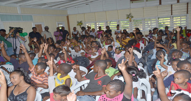Children of Sandvoort lift their hands in response to President David Granger on Sunday(Delano Williams Photo)