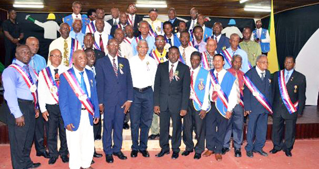 President David Granger flanked by some of the men honoured by the National Association of Adventist Men's Ministry for their longstanding service and dedication