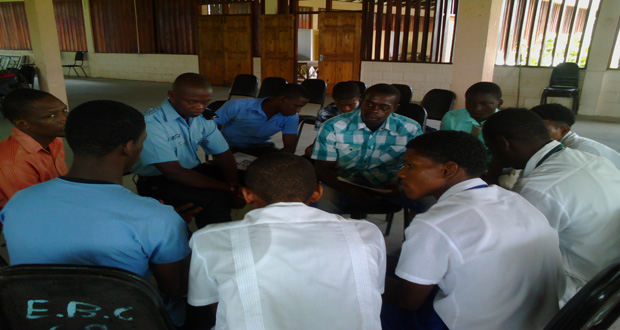 A group of men in discussion at the forum