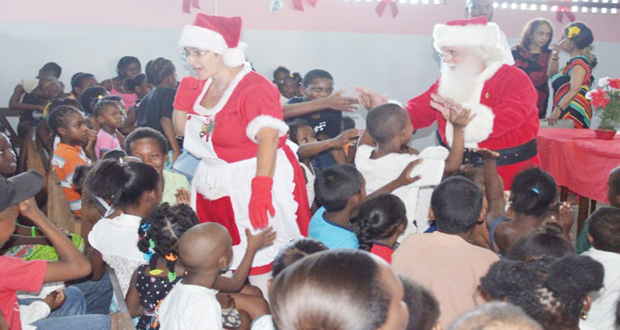 Mr and Mrs Claus move through the audience of children at the Dharam Shala Children’s party yesterday afternoon (OPM photo)