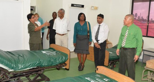 Savitri Chandrabose, staff nurse at the Leonora Diagnostic Centre (left), gestures while speaking to President David Granger, as Minister of Public Health, Dr George Norton; Director of Regional Health Services, Dr Kay Shako; and Centre Administrator Dev Hira listen during a guided tour of the old maternity wing of the hospital (Ministry of the Presidency photo)