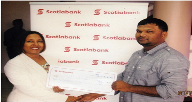 SCOTIABANK Marketing executive Jennifer Cipriani hands over cheque to RHTYSC executive Mark Papannah.