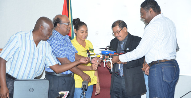 Minister of Indigenous People’s Affairs and third Vice-President Sydney Allicock, inspects the drone in the presence of the NAREI Director Dr. Oudho Homenauth, Agriculture Ministry PS George Jervis and Assistant Professor at the University of Texas, Dr. Anthony Cummings.