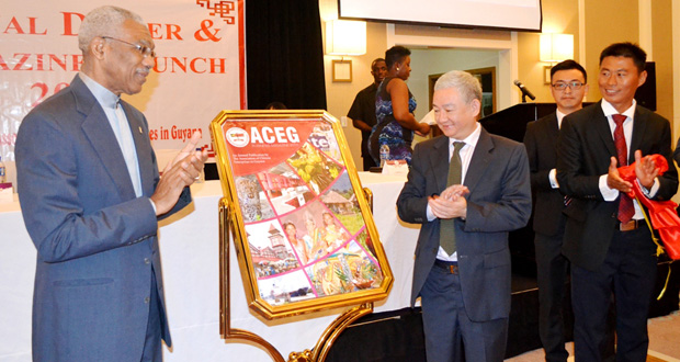 President David Granger, left, and Chinese Ambassador to Guyana, Zhang Limin, applaud after unveiling the 2016 Business Magazine of the Association of Chinese Enterprises in Guyana (ACEG)
