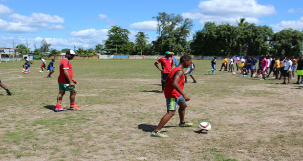 Coaches and participants of the Alex Bunbury football clinic at the Mackenzie Sports Club ground in Linden yesterday.