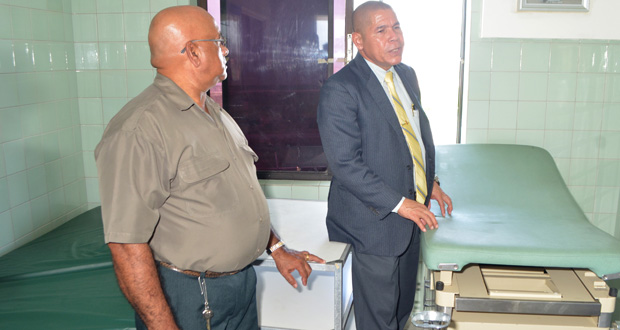 Minister of Public Health, Dr George Norton, inspects a bed in the non-functioning Maternity Ward of the Leonora Cottage Hospital. Looking on is Regional Executive Officer Dennis Jaikaran. (Cullen Bess-Nelson photo)