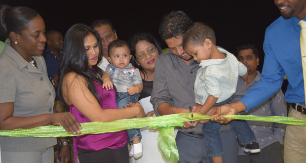 Ramnaresh Sarwan and his son cut the ribbon for the opening of Fitness 53 Gym