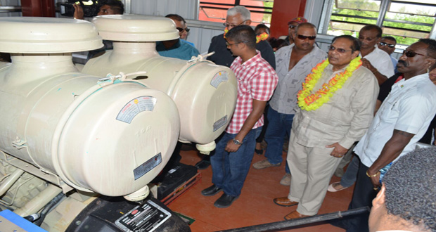 Prime Minister Moses Nagamootoo and Agriculture Minister Noel Holder inspect the newly installed drainage pump at Lima