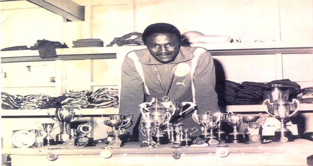 Victor Benjamin displays his silverware from a track meet in the 1970s