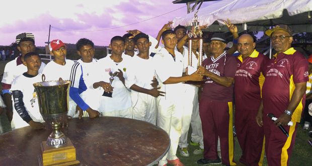 Inderjeet Mohan, brother of HACC president Narchand “Archie” Mohan presents the winning Mohan Memorial trophy to Blairmont Raiders skipper Zameer Inshan. HACC president Narchand Mohan and manger Frederick Halley are at extreme right.