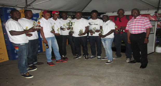 George McDonald and Linden Branch Manager Shondel Easton pose with the Bulls team.