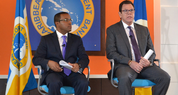 CDB President, Dr Warren Smith (right), and the bank’s Director of Economics, Dr Justin Ram, taking questions at yesterday’s media conference