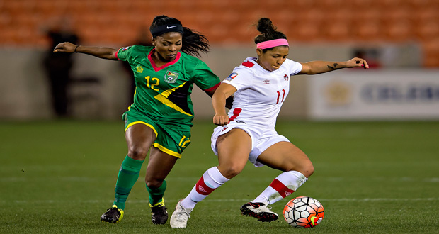 Otesha Charles (Guyana) battles Desiree Scott (Canada) for the ball at the BBVA Compass Stadium last evening.