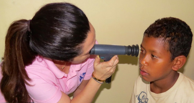 A young Mabaruma resident being screened by Optometrist Dr. Shannon Da Silva. (Ministry of Public Health photo)