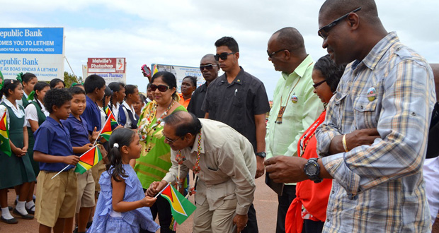 Prime Minister Moses Nagamootoo, with wife Sita, listens to a nursery school student soon after he arrived at Lethem on Saturday morning. Also in photo, from the Prime Minister’s left, are Ministers Joseph Harmon, Volda Lawrence and David Patterson