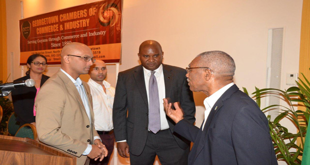 President Granger makes a point to outgoing President of the GCCI, Mr. Lance Hinds (left) and Senior Vice-President, Mr. Vishnu Doerga after the opening of the AGM  at the Pegasus Hotel