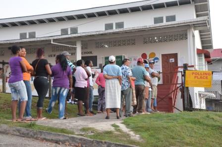 These persons gathered at the Hill View Polling Station were anxiously awaiting the opening of polls. [Delano Williams photo]