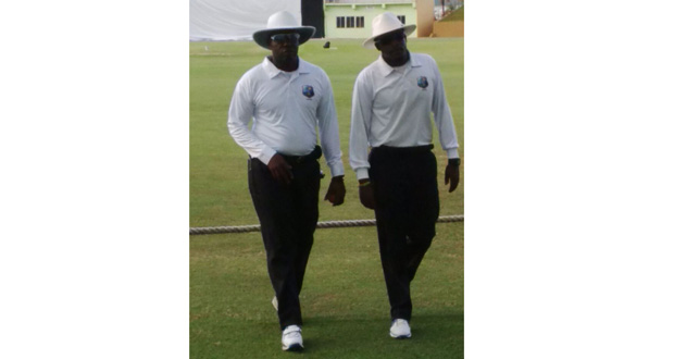 Umpire Shannon Crawford (left) and Barbadian colleague Leslie Reifer (Jr) leave the field at the end of play on day one..