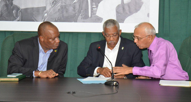 Minister of Communities Ronald Bulkan makes a point to President David Granger while Minister of State Joseph Harmon listens during Saturday’s press conference on Local Government Elections (Ministry of the Presidency photo)