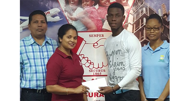 Hand-in-Hand employee Eshwarie Persaud (left), hands over sponsorship cheque to YWCC, Guyana and West Indies Youth batting sensation, Shimron Hetmyer, in the presence of Berbice Manager Tajpaul Adjhodea and another staff member of Hand-in-Hand.