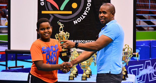 Kaysan Ninvalle collects his Under-11 trophies during last weekend’s GTTA National Junior and Cadet Table Tennis Championships. (Samuel Maughn photo)