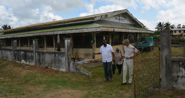 Minister Ronald Bulkan, community leader Noreen Duncan, and Region Two REO Rupert Hopkinson in discussion after inspecting the old Good Hope Market Centre in Essequibo