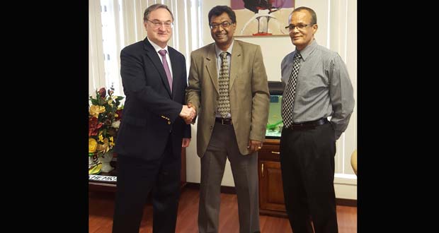 Public Security Minister Khemraj Ramjattan shaking hands with the Russian Ambassador to Guyana Nikolay Smirnov in the presence of Coordinator of the Task Force on Narcotic Drugs and Illicit Weapons, Major General (Retired) Michael Atherly.