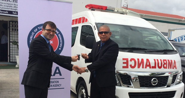 Associate Professor of International Relations and Director of South America of TIKA, Mehmet Ozkan hands over the keys for the ambulances to Public Health Minister, Dr. George Norton.