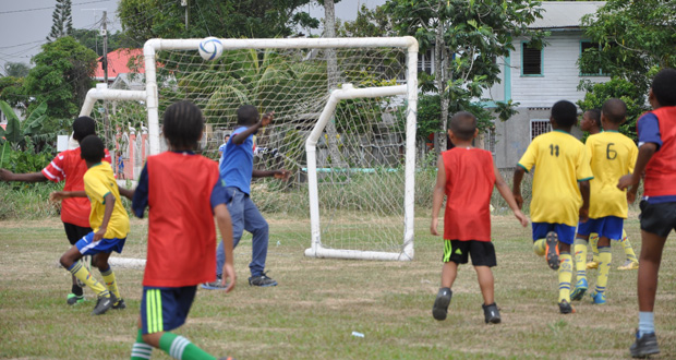 Tyrese Jones (2nd left) watches as his lobbed ball over the goalkeeper’s head is destined for the back of the nets.