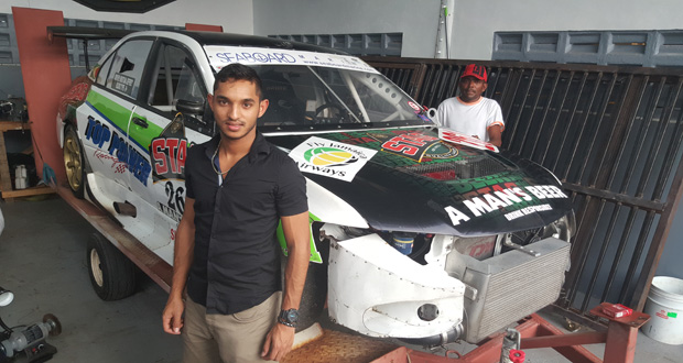 Kristian Jeffrey stands with his two-time championship winning STAG and Fly Jamaica-sponsored Mitsubishi Evolution 9.