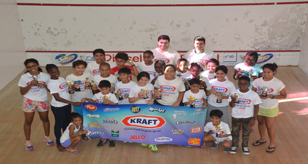 Winners of the various categories in the Kraft/Toucan Industries Junior Skills Level Squash Tournament strike a pose for photographer Delano Williams shortly after receiving their prizes yesterday at the Georgetown Club courts.