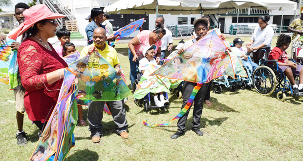 Mrs Sita Nagamootoo distributing kites to children of the Ptolemy Reid Rehabilitation Centre