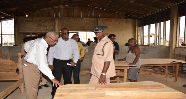 President David Granger and Minister of State, Mr. Joseph Harmon, examining some of the work done by inmates at the Mazaruni Penal Settlement
