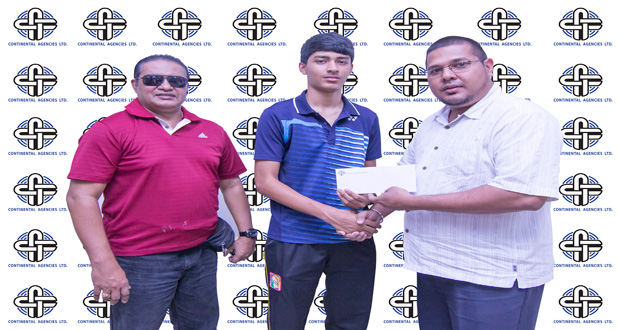 Avalon Jagnandan, Marketing and Sales Manager for the Continental Group of Companies hands over the sponsorship cheque to. Narayan Ramdhani in the presence of Gokarn Ramdhani, his father and coach and who is also the president of the Guyana Badminton Association (GBA).