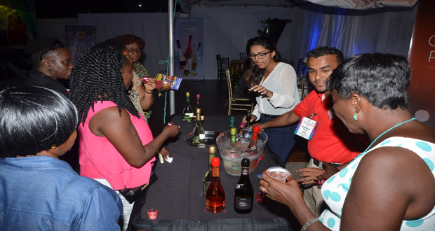 Persons delighted with the cocktails at Ansa McAL’s booth