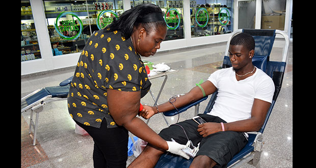 A Giftland Mall patron donating his pint yesterday during the company’s  blood drive (Photo by Samuel Maughn)
