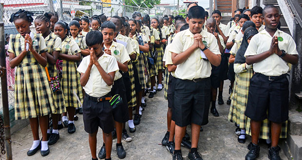 Students of the Peter’s Hall Primary School, East Bank Demerara,
pray in the school’s compound before the start of the National Grade
Six Assessment, Wednesday. (Samuel Maughn photo