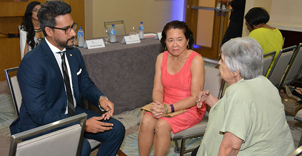 First Lady Mrs. Sandra Granger (centre) and Mr. Richard Sammy, Managing Director of Republic Bank, pay keen attention to Dr. Suraiya Ismail, Chair of the Step by Step Foundation, as she makes a point during a brief interaction before the start of the reception 