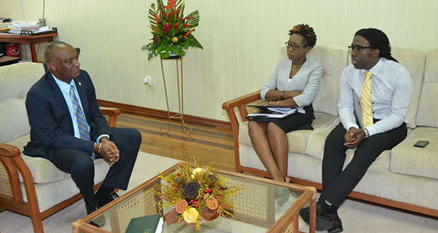Monitoring and Evaluation specialist and Head of the Project Management Office,  Marlon ,and Head of the Office of Climate Change, Janelle Christian, during the meeting with Minister of State Joseph Harmon.