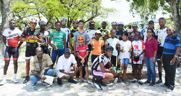 Prize winners of the various categories of yesterday’s Universal Auto Sales and Spares 11-race cycle programme strike a pose with Zayd Baksh (sixth left) son of programme sponsor Shameer Baksh (photo by Ivan Bentham).