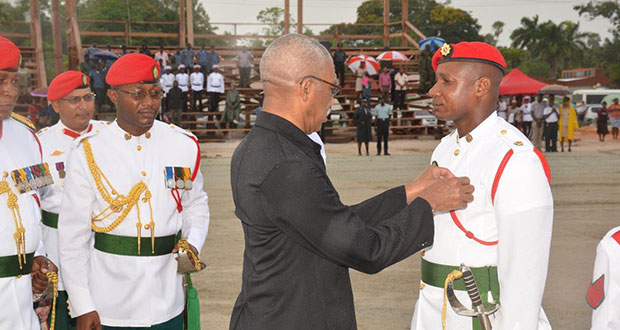 A serviceman from the Guyana Defence Force stands tall as President David Granger pins a medal on his pocket