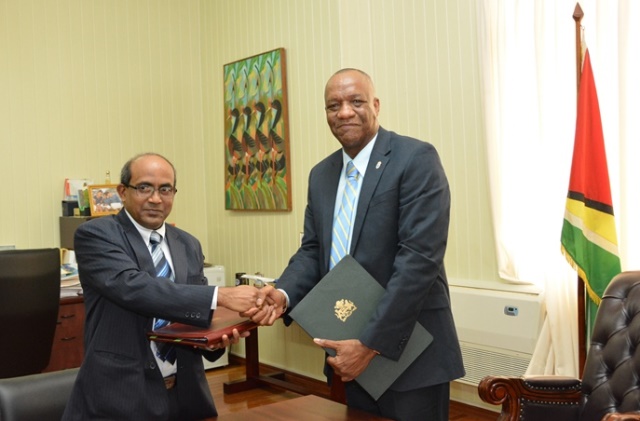 Indian High Commissioner to Guyana, Mr. Venkatachalam Mahalingam and Minister of State, Mr. Joseph Harmon shake hands after signing the MoU.