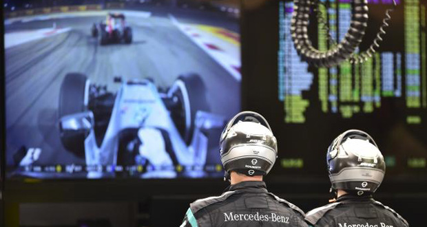 Technicians watch the Bahrain Formula One Grand Prix. (Reuters/Andrej Isakovic/Pool)