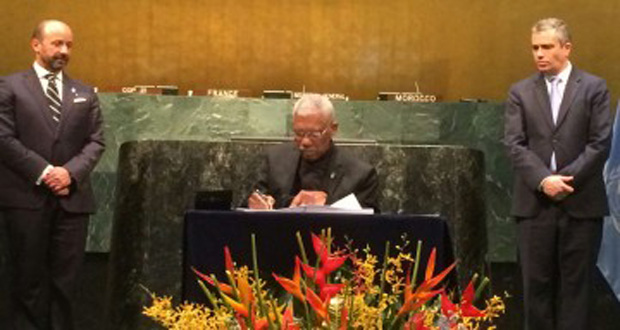 President David Granger signs the ambitious Paris Agreement at the UN, New York, on Friday (Ministry of the Presidency photo)