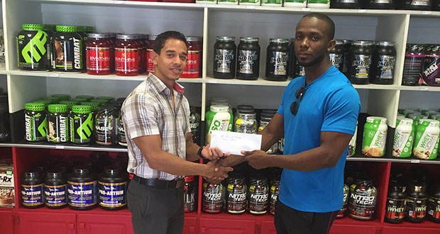 Owner/Proprietor of Fitness Express Jamie McDonald hands over a sponsorship cheque to GAPLF PRO Paul Adams.