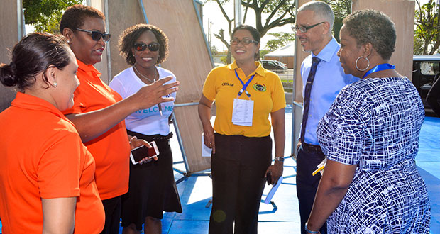 Minister of Business, Dominic Gaskin (second from right), conversed with GTT+ officials during his tour of the exhibition site on Monday (Samuel Maughn photo)